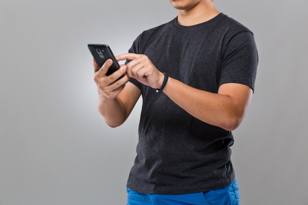 Man with smart device and use of mobile phone